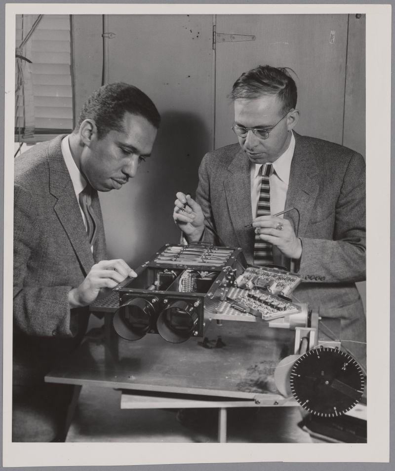 John W. Brean and Martin Osman work on digital camera