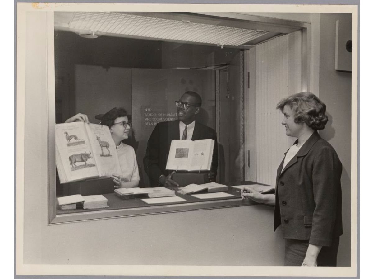 Marilyn Peterson, Karl Bynoe and Georgia Andrews with rare books, 1970s